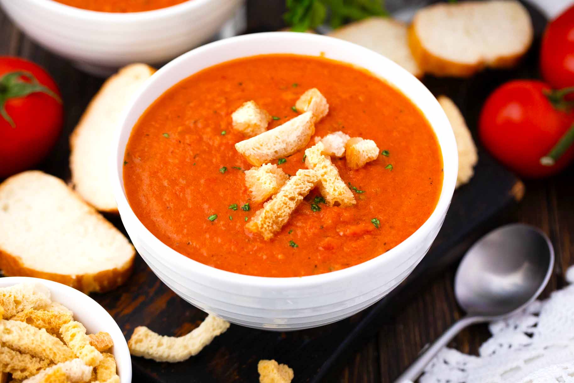 a bowl of panera bread creamy tomato soup topped with croutons