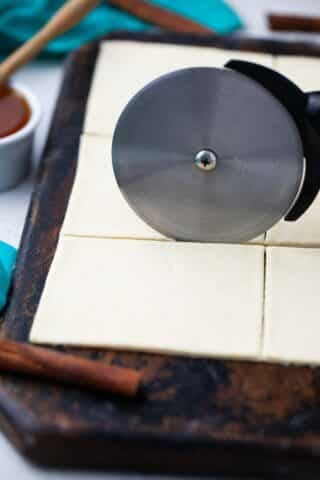slicing sopapilla dough into squares