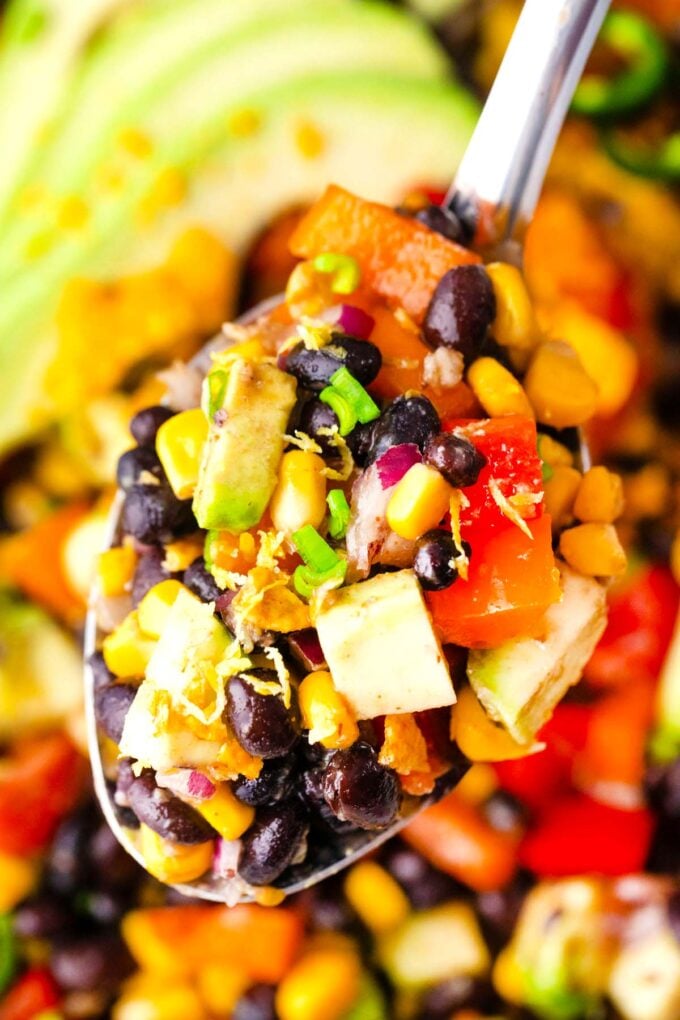 A serving spoon of homemade Mexican black bean salad.