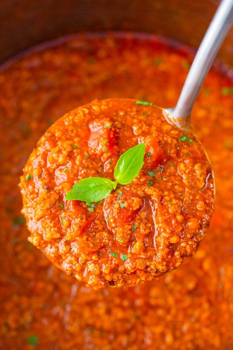 A ladle of meaty Instant Pot spaghetti sauce.