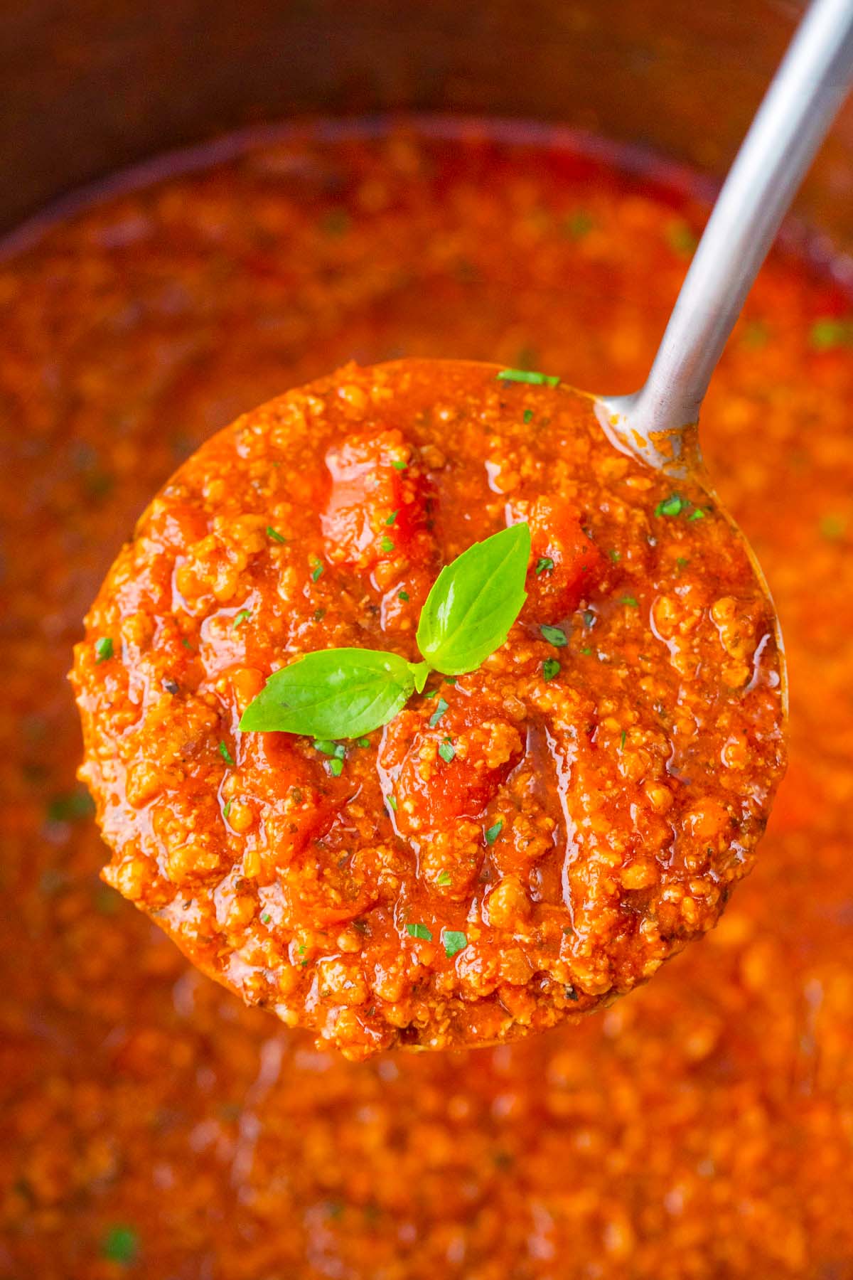 A ladle of meaty Instant Pot spaghetti sauce.