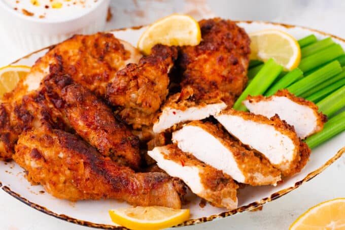 A plate of crispy air fryer fried chicken served with celery.