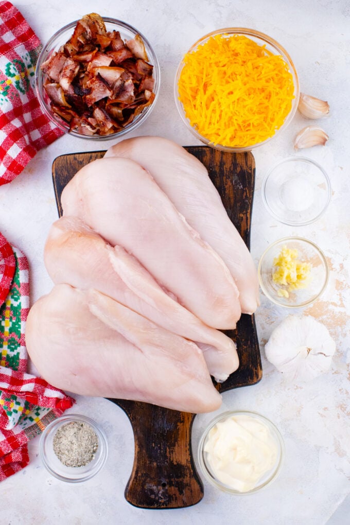 Overhead shot of baked crack chicken ingredients arranged on a table.