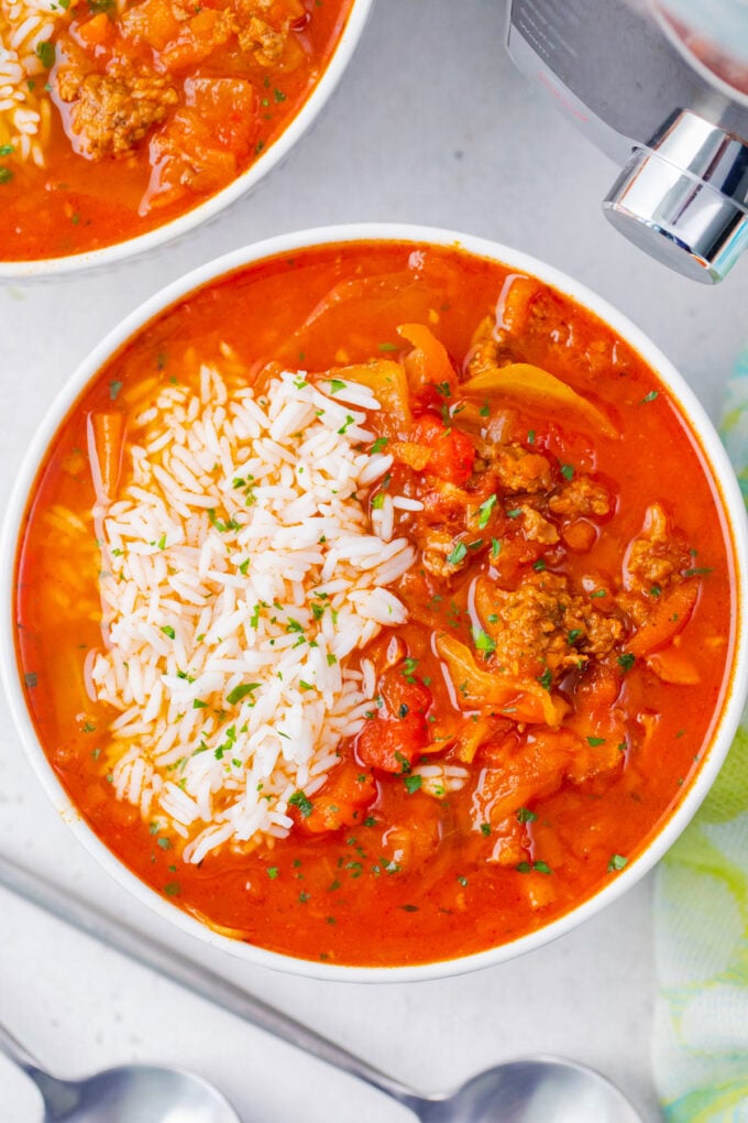 Overhead shot of a bowl of instant pot cabbage roll soup served with rice.