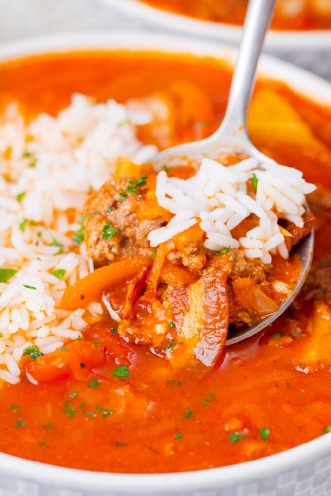 A spoonful of instant pot cabbage roll soup with bacon and rice.