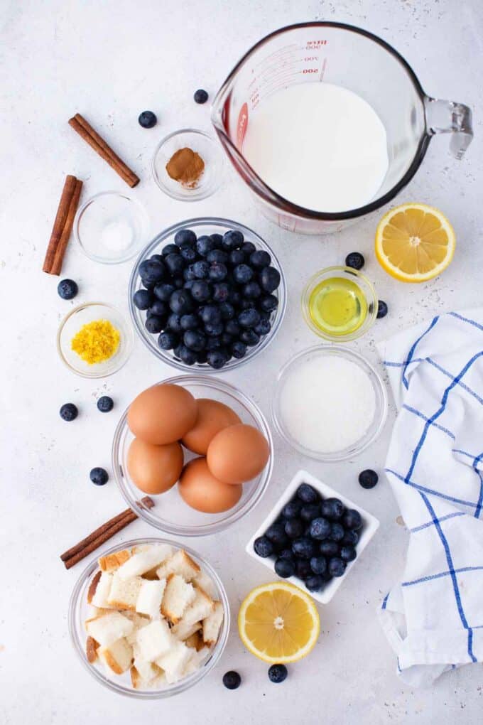 blueberry french toast casserole ingredients in bowls on a white surface