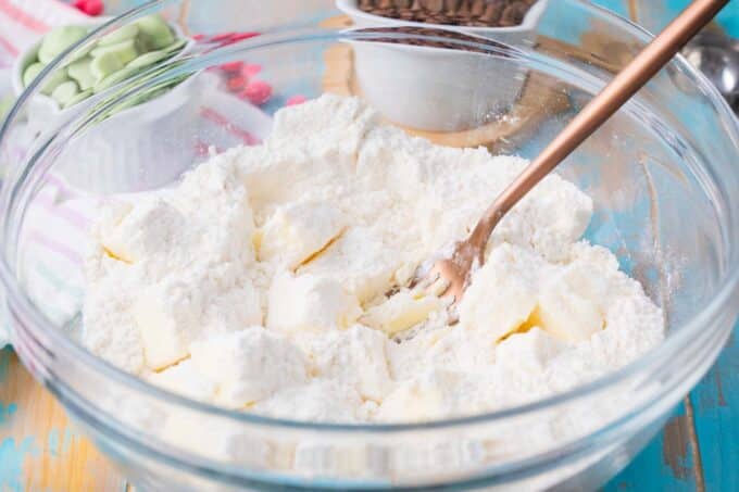 Mixing cake mix and butter in a bowl.