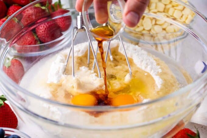 Preparing white cake mix in a bowl.