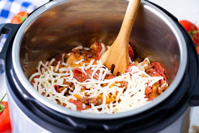 Adding cheese to instant pot pizza pasta.