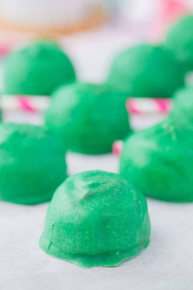 No bake, green, watermelon truffles on a baking sheet.