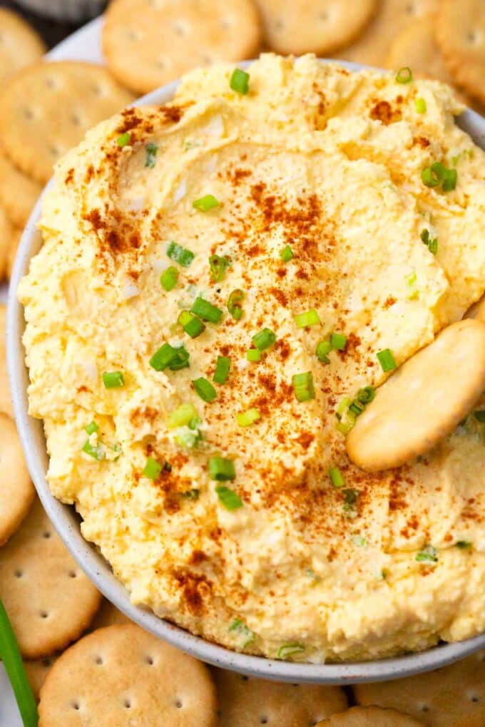 creamy deviled eggs dip topped with paprika and chives