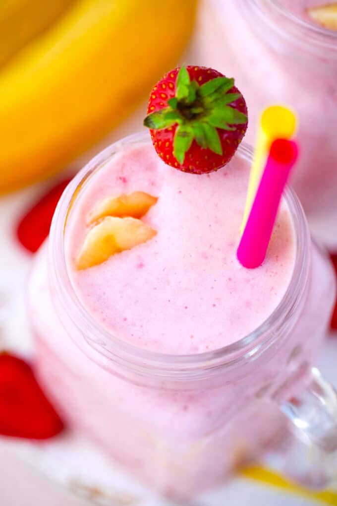 Overhead shot of a glass with strawberry banana smoothie.