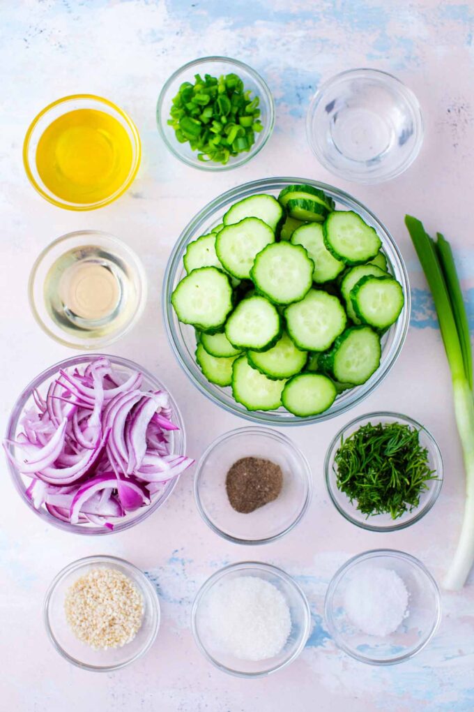 cucumber salad ingredients in bowls on a table