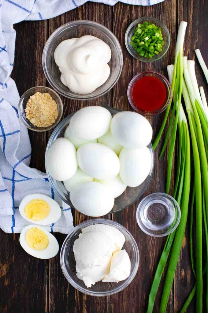 deviled eggs dip ingredients in bowls on a table