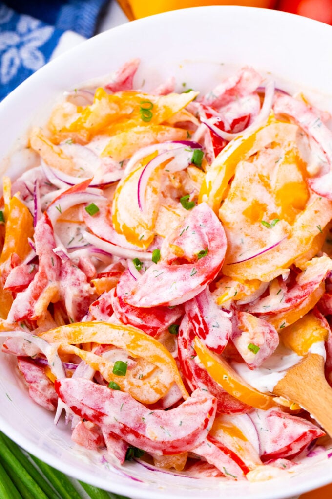Overhead shot of creamy tomato salad made with yellow and red heirloom tomatoes.