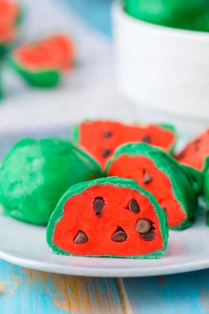 No bake watermelon truffles sliced in two on a plate.