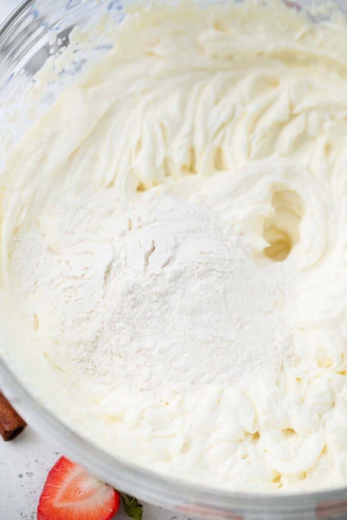 beating flour into cream cheese mixture