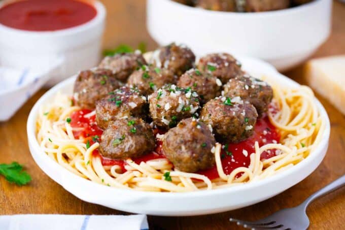 juicy homemade Italian meatballs on top of spaghetti with marinara sauce