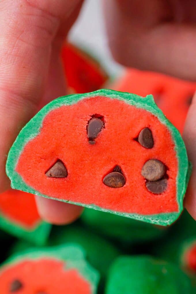 Close shot of no bake watermelon truffle with mini chocolate chips as seeds.