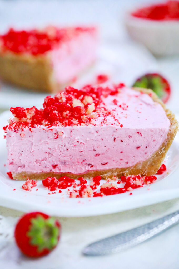 A slice of strawberry shortcake pie of strawberry crumb topping.