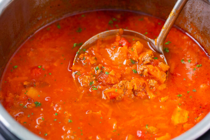 Instant pot cabbage roll soup with a ladle in it.