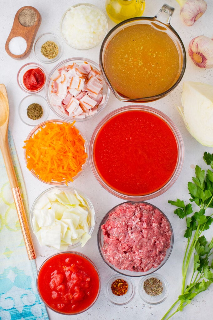 Overhead shot of instant pot cabbage roll soup ingredients in bowls on a table.