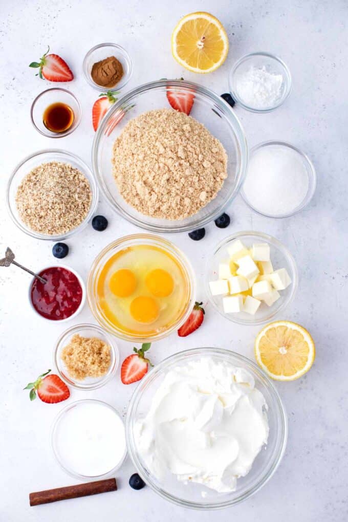 overhead shot of instant pot cheesecake ingredients in bowls on a white surface