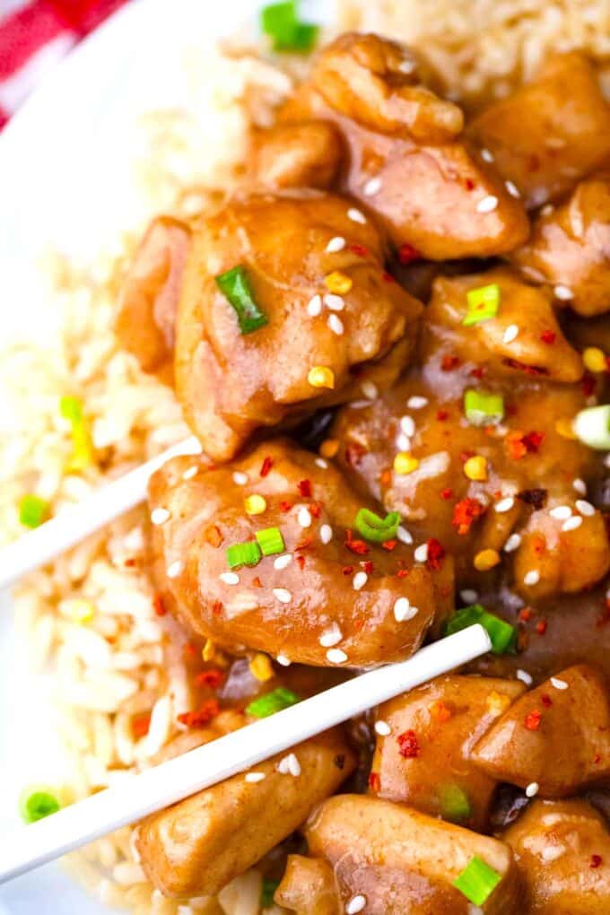 chopsticks holding juicy instant pot garlic sesame chicken