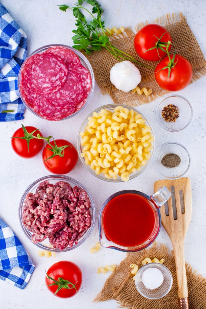 Overhead shot of instant pot pizza pasta ingredients in bowls on a table.