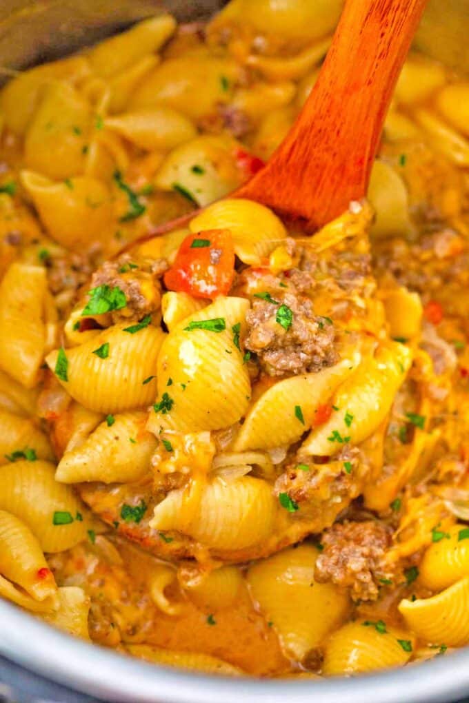 a ladle of cheesy taco pasta in the instant pot