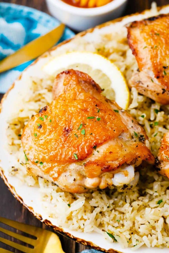 one pan Italian chicken and rice on a serving plate with lemon wedges