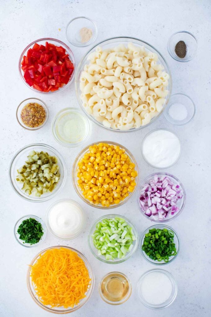 macaroni salad ingredients in bowls on a table