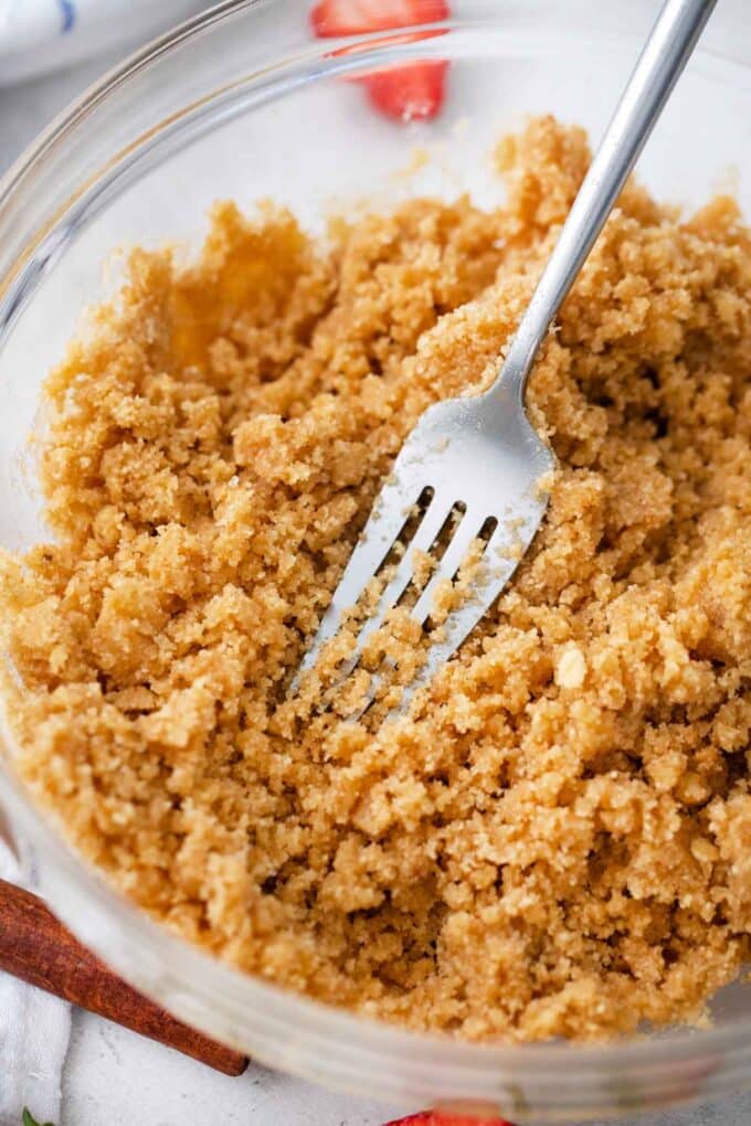 mixing graham crust ingredients in a bowl