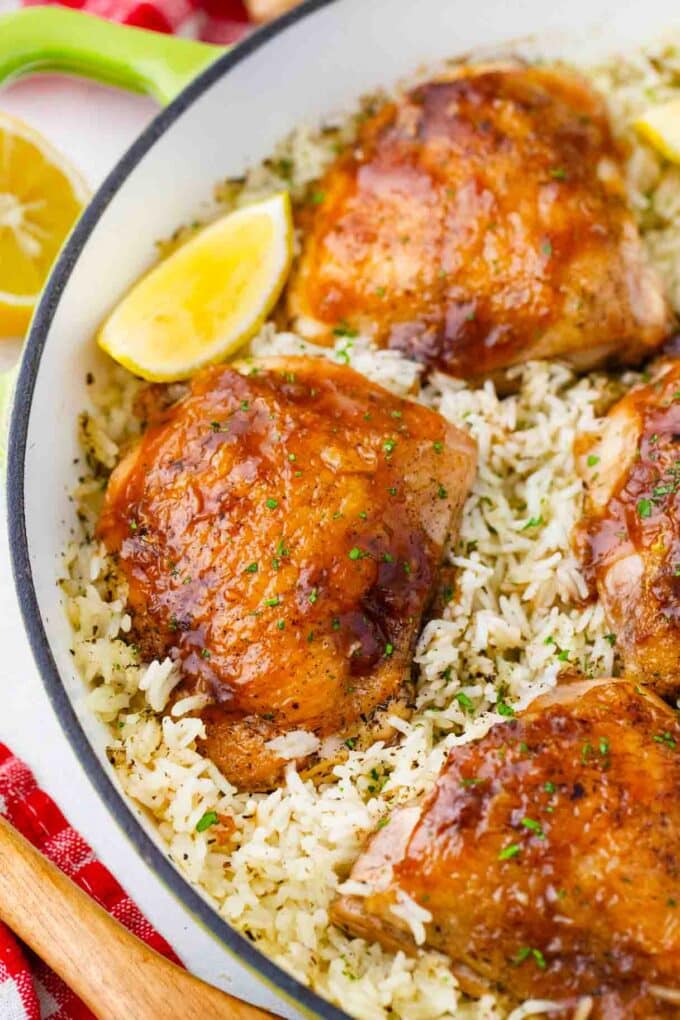 nicely browned one pan honey garlic chicken and rice with a lemon wedge