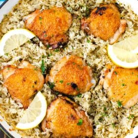 overhead shot of one pan italian chicken and rice garnished with lemon slices