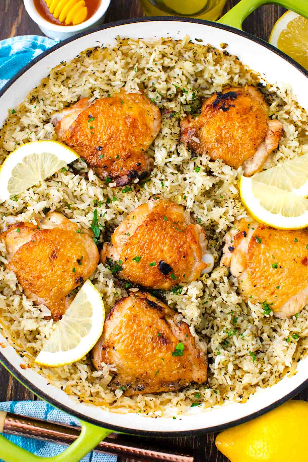 overhead shot of one pan italian chicken and rice garnished with lemon slices