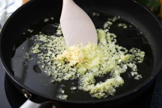 sautéing onion and garlic in a cast iron