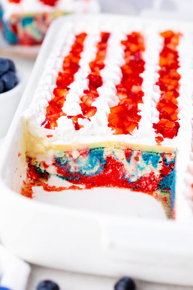 Sliced patriotic poke cake in a pan.