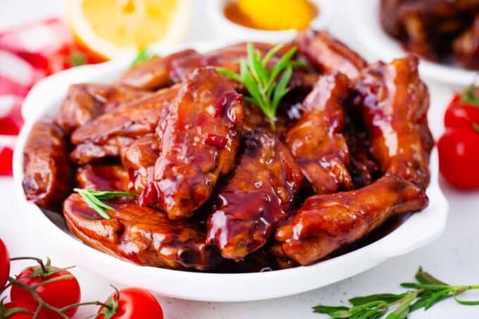 a plate of red wine glazed wings