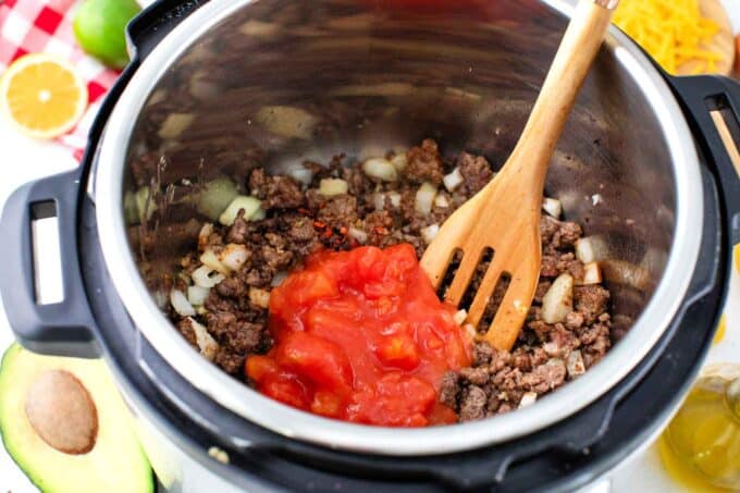 instant pot with ground beef, taco seasoning, and salsa to make taco pasta