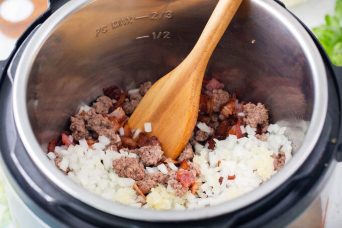 Searing beef, garlic, and onion in the Instant pot.