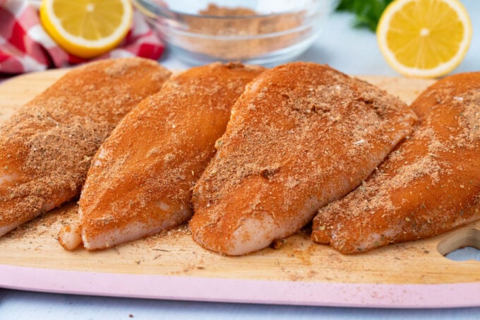 Chicken breasts seasoned with blackened spices.
