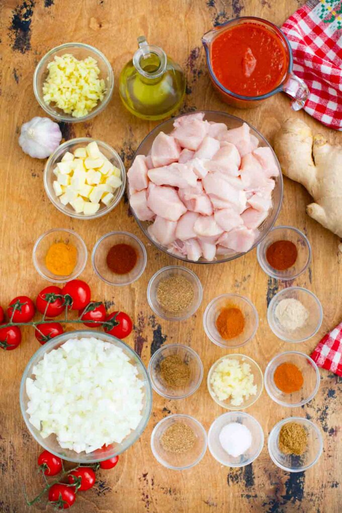 slow cooker butter chicken ingredients ingredients in bowls on a table