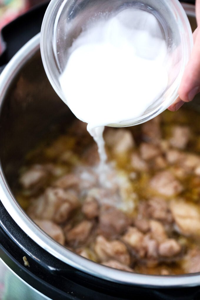 Adding a cornstarch slurry to Instant Pot garlic sesame chicken.