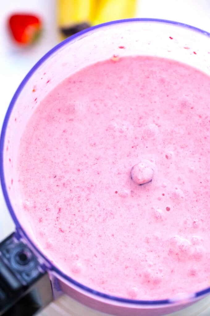 Strawberry banana smoothie in a blender.