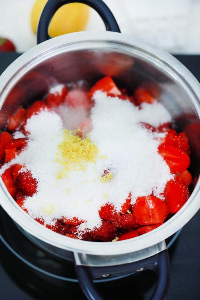 Strawberry sauce ingredients in a saucepan.