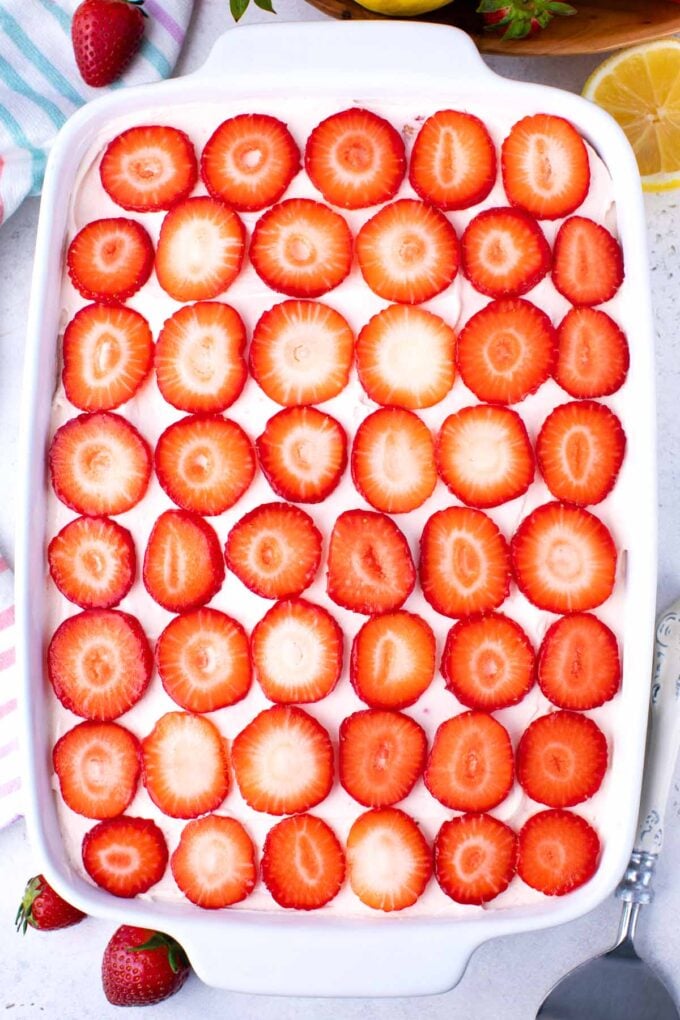 Overhead shot of strawberry tiramisu topped with sliced strawberries.
