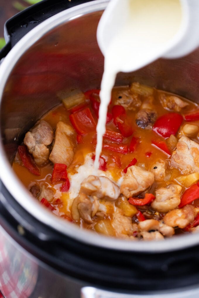 Adding cornstarch slurry to Instant Pot sweet and sour.