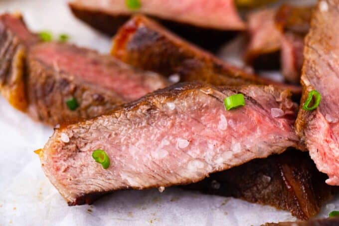 Sliced Asian style grilled steak topped with sea salt.