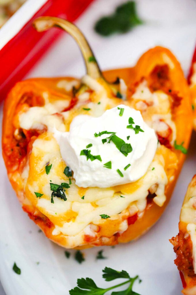 Mexican stuffed pepper topped with cheese and sour cream.